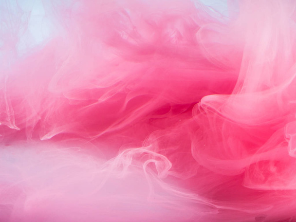 Abstract colored background. Pink smoke, ink in water, the patterns of the universe. Abstract movement, frozen multicolor flow of paint. Horizontal photo with soft focus, blurred backdrop - Фото, изображение