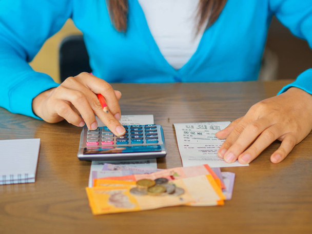 женщина, работающая с калькулятором, бизнес-документом и ноутбуком
 - Фото, изображение