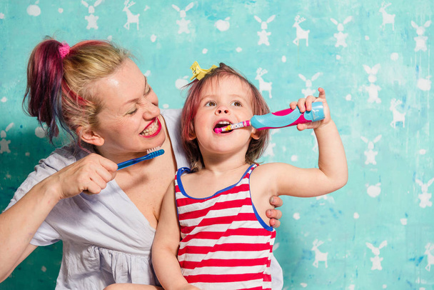 Toothbrush. Mom teaches a little daughter to brush their teeth - Fotoğraf, Görsel