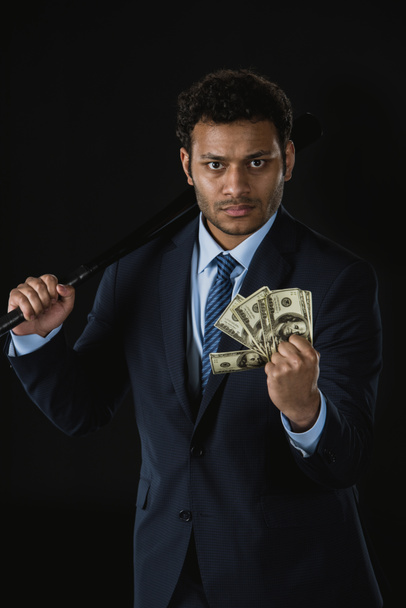 Businessman with bat and money  - Фото, изображение