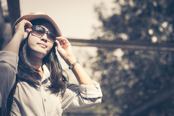 Beautiful young asian woman wearing round hat on a park ,travel in a summer day - 写真・画像
