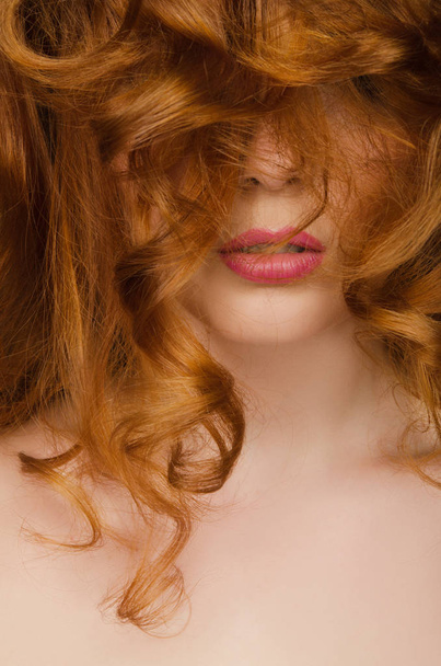 Beautiful red hair on the face of woman - Фото, зображення