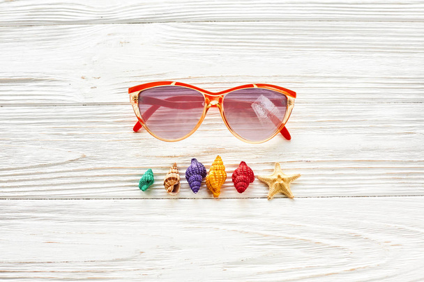 sunglasses and colorful shells - 写真・画像