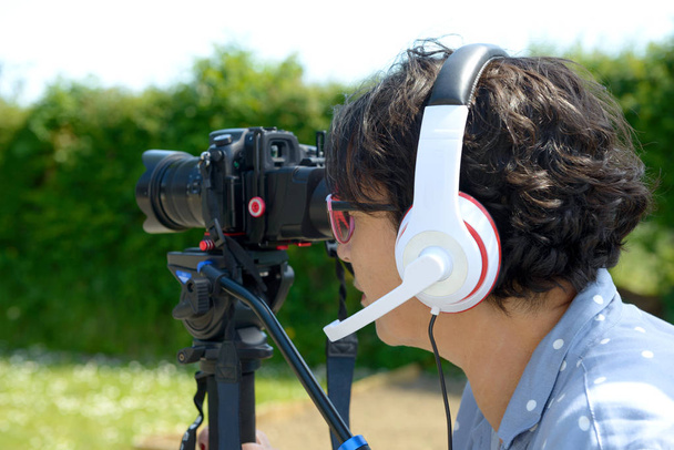 woman with headphones, using  camera dslr - Photo, Image