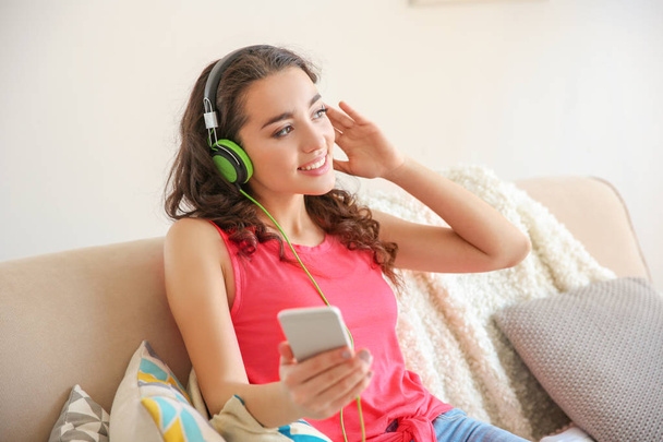Beautiful young woman listening to music  - Фото, изображение