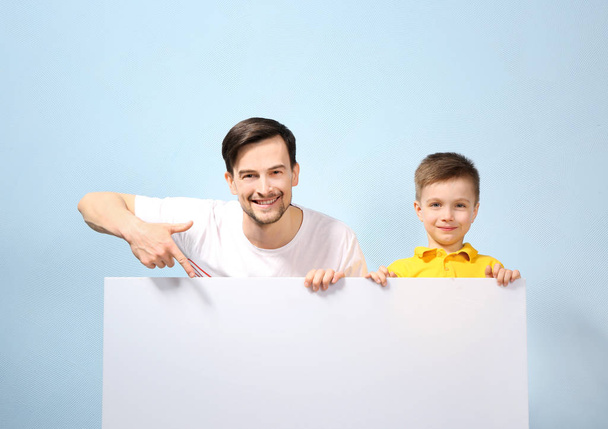 Handsome man and son with poster  - Zdjęcie, obraz