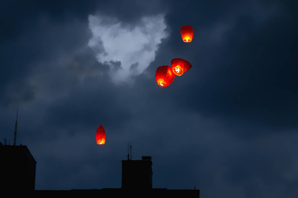 Sky lanterns over heart shaped clouds - Photo, Image