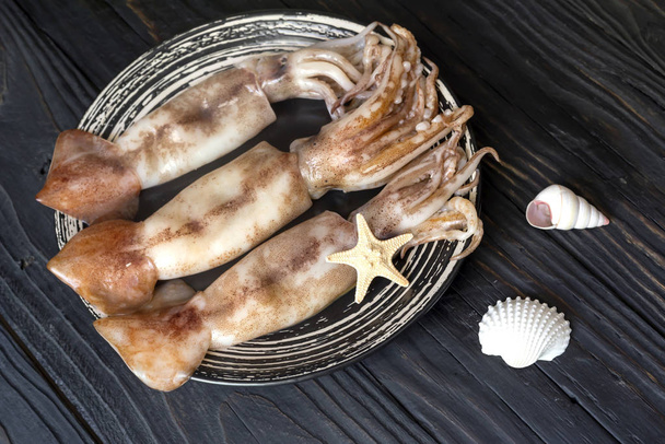 Raw squids on a wooden table - Photo, Image