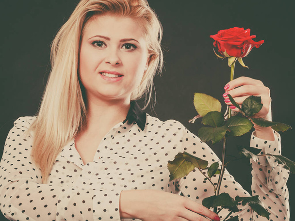 Woman holding rose flower on black - Foto, Bild