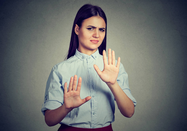 Upset woman repulsing something with hands stop gesture   - Photo, image