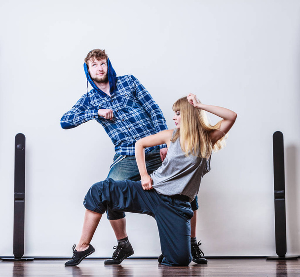 couple of young man and woman dancing hip-hop - 写真・画像