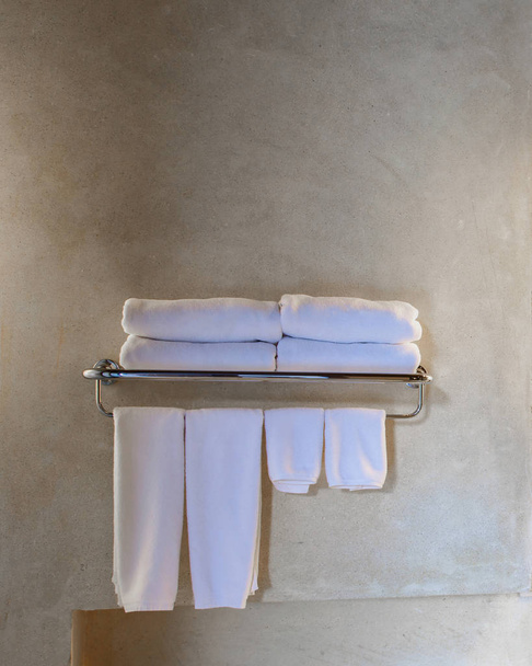 μοντέρνο μαρμάρινο νιπτήρα στην τουαλέτα ή το ξενοδοχείο μπάνιο με προϊόντα περιποίησης και φρέσκο καθαρές πετσέτες - Φωτογραφία, εικόνα