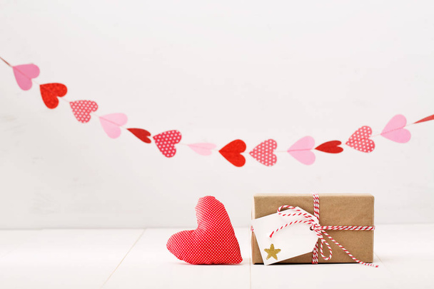 Little gift box with hearts hanging above - Foto, immagini