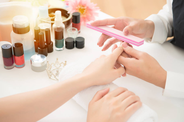 chinese manicurist is applying nail file - Foto, Imagem