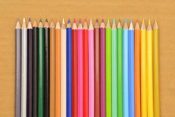 Colored Pencils on Brown Background - Photo, Image