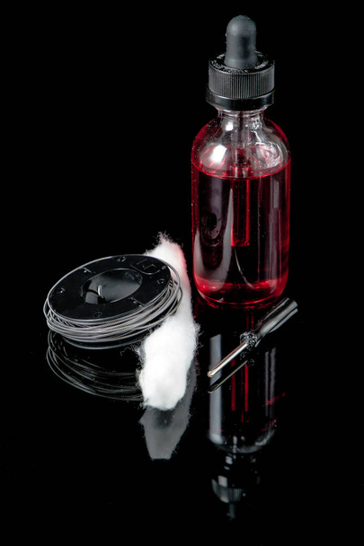 Electronic cigarette juice with cotton wick,screwdriver and coil - Photo, Image