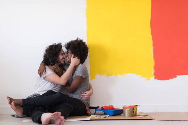 young multiethnic couple relaxing after painting - 写真・画像