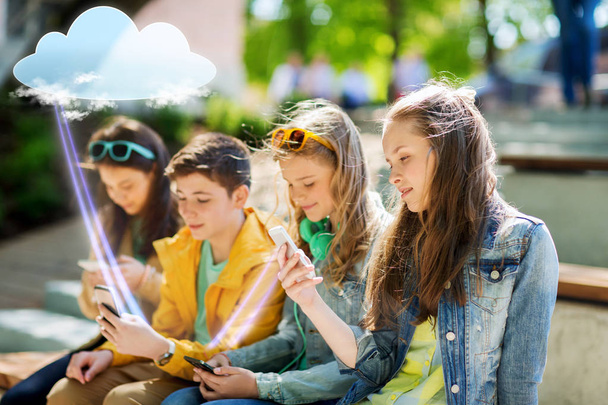 happy teenage friends with smartphones outdoors - Photo, image
