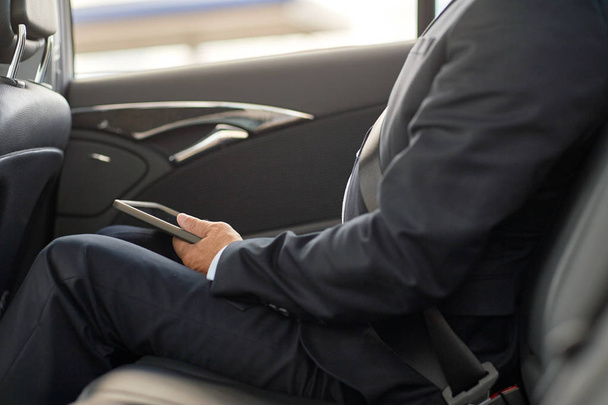 senior businessman with tablet pc driving in car - Фото, зображення