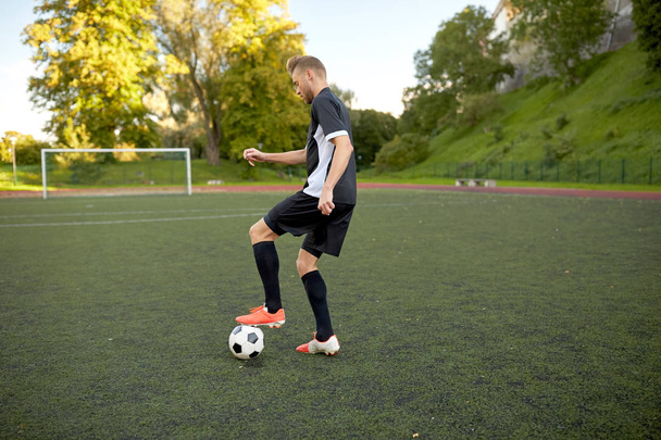 soccer player playing with ball on football field - Φωτογραφία, εικόνα
