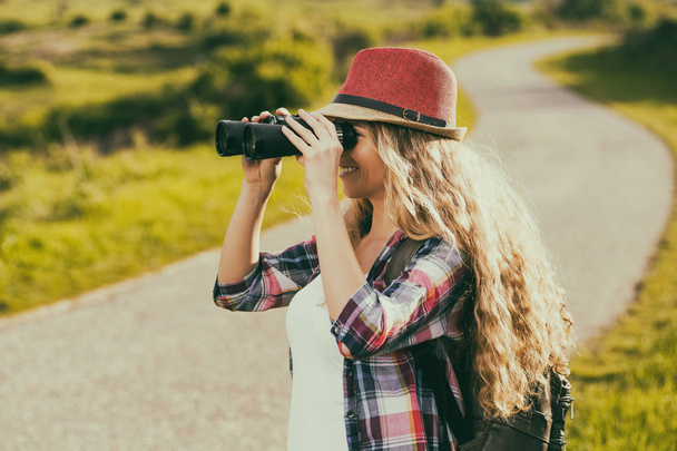 Woman looking through binoculars - Φωτογραφία, εικόνα
