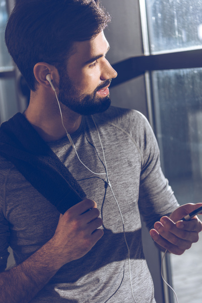 man listening music in earphones - Photo, Image