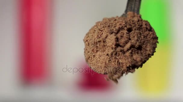 Turmeric powder falling from the silver spoon. Blurred background. Slow motion - Footage, Video