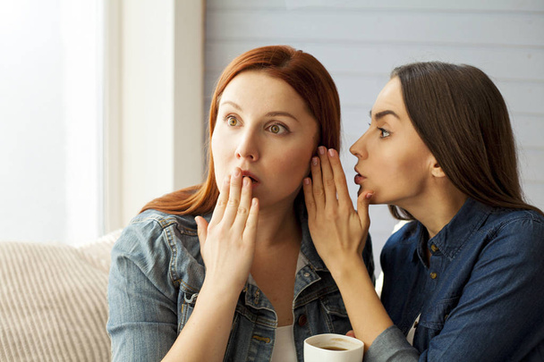 woman telling secret to her friend - Фото, изображение