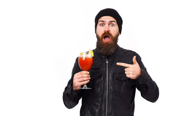 Brutal caucasian hipster holding alcoholic beverage or fresh cocktail - Photo, image