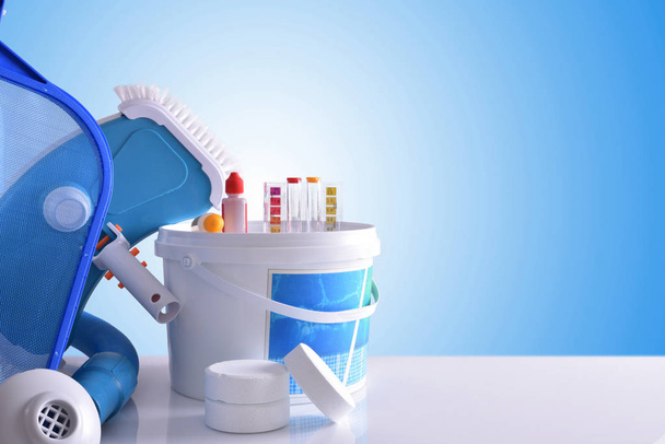 Chemical cleaning products and tools for pool blue background - Фото, зображення