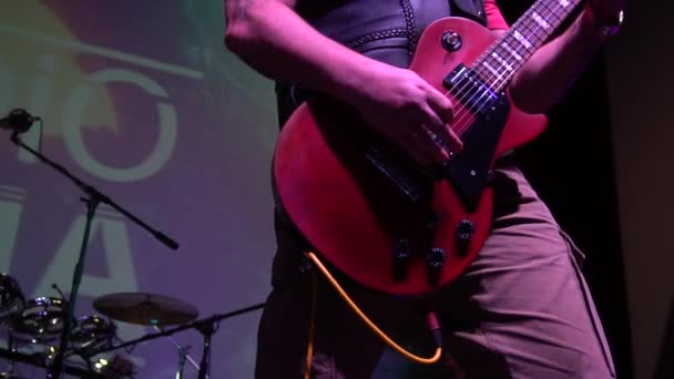 The musician plays solo on acoustic electro bass guitar at a rock concert - Video
