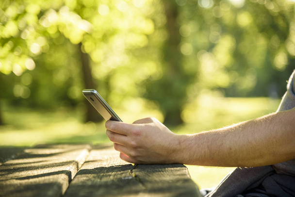 Man using smartphone in nature. - Foto, immagini
