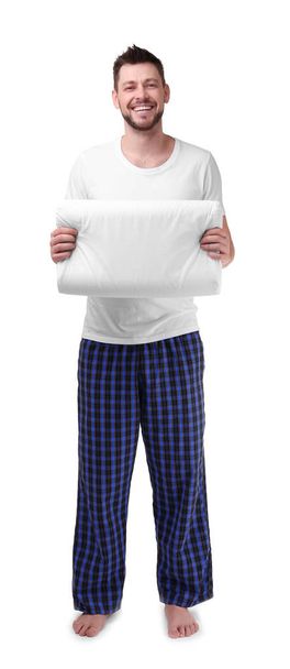 Young man in pajamas holding pillow - Foto, Imagem