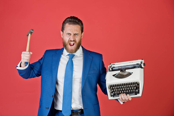 business man, aggressive businessman with typewriter and hammer - Foto, afbeelding
