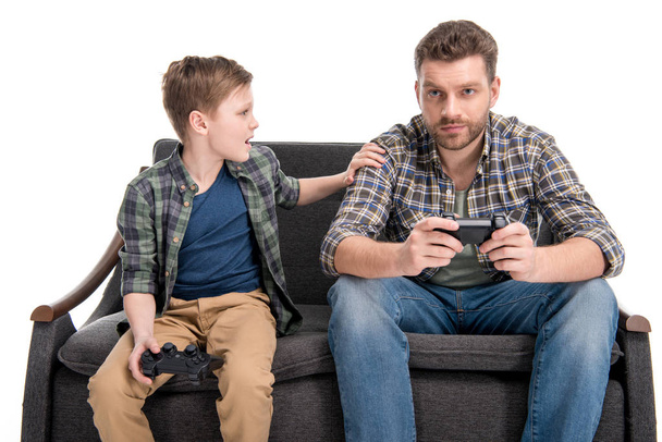 Father and son playing with joysticks - Foto, imagen