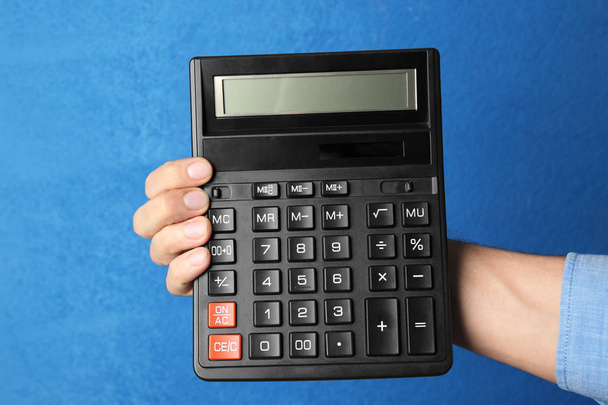 Male hand holding calculator   - Photo, image