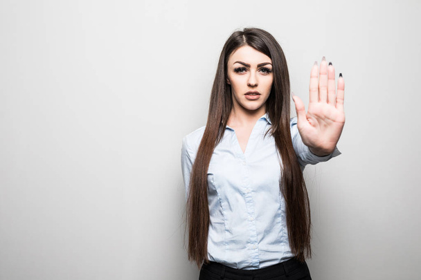 Closeup portrait young annoyed angry woman with bad attitude giving talk to hand gesture with palm outward isolated grey wall background. - Photo, Image