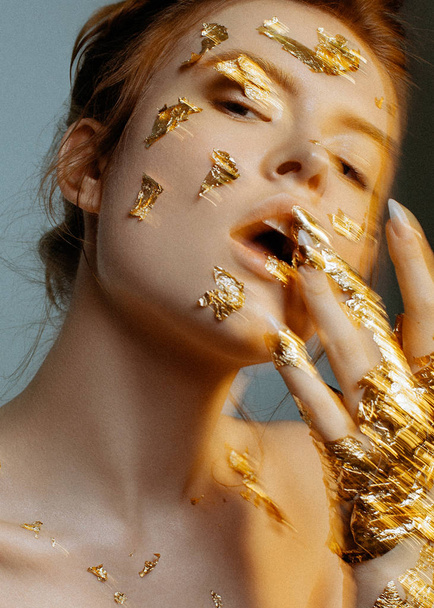 Emotional beauty portrait of young fashion model with golden make-up. - Photo, Image