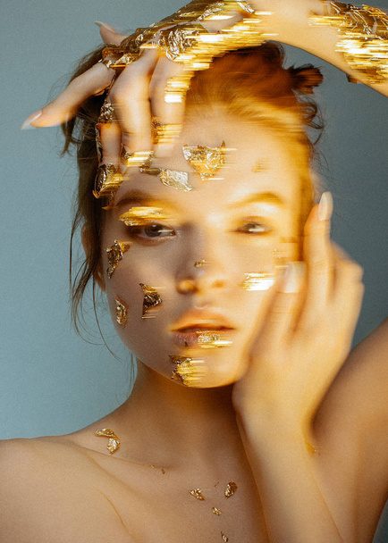 Beauty portrait of young fashion model with golden make-up. - Фото, изображение