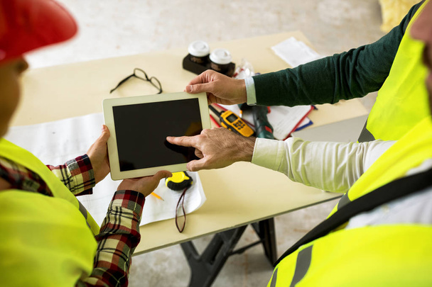 Engineers with tablet at construction site - Foto, Bild