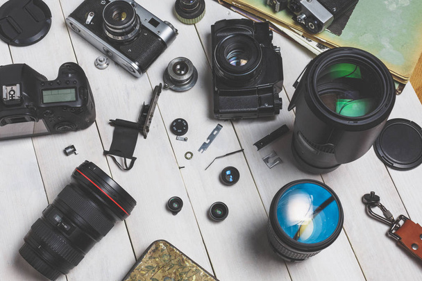 Film cameras, components, digital cameras, and lenses on wooden white background technology development concept - Φωτογραφία, εικόνα
