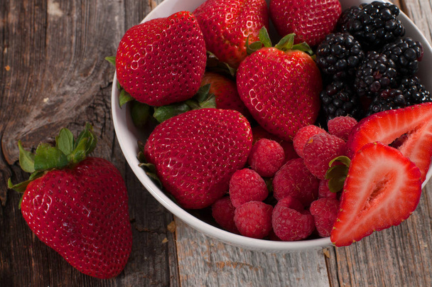 Assorted fresh juicy berries in bowls - Zdjęcie, obraz