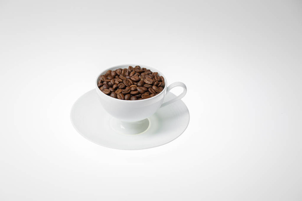 Coffee beans with in coffee cup on white background - Foto, imagen