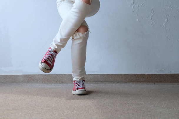 Closeup Photo of From Woman Wearing Red Sneakers On The Concrete Floor Background - Foto, Bild