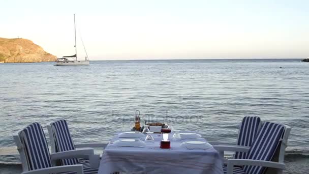 stole w pobliżu morza i łodzi żaglowych  - Materiał filmowy, wideo