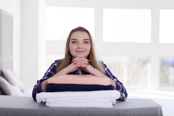    Młoda kobieta patrzy na aparat. Ręczniki pod ręce - Zdjęcie, obraz