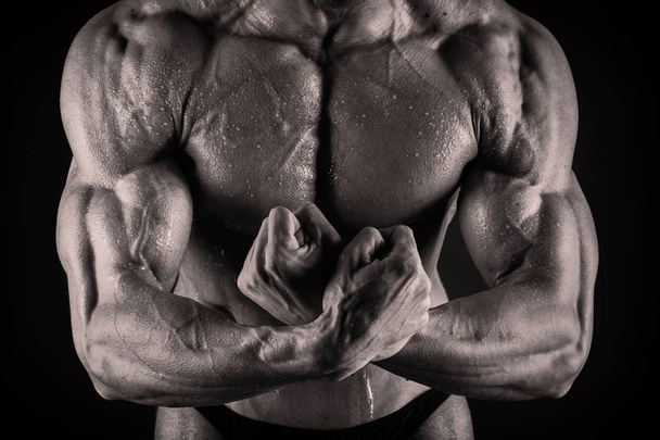 Culturista mostrando sus músculos de espalda y bíceps, fitnes personales
 - Foto, imagen