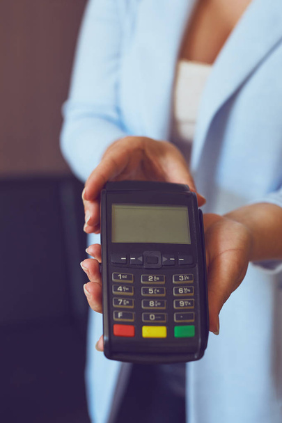 Woman holding a payment terminal - Photo, Image