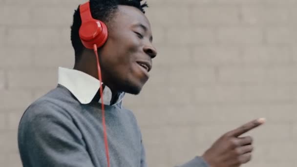 African american man listen music with headphones - Кадри, відео