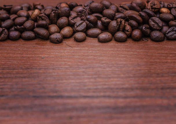 Black coffee beans on a brown tree - Photo, Image
